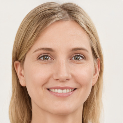 Joyful white young-adult female with medium  brown hair and green eyes