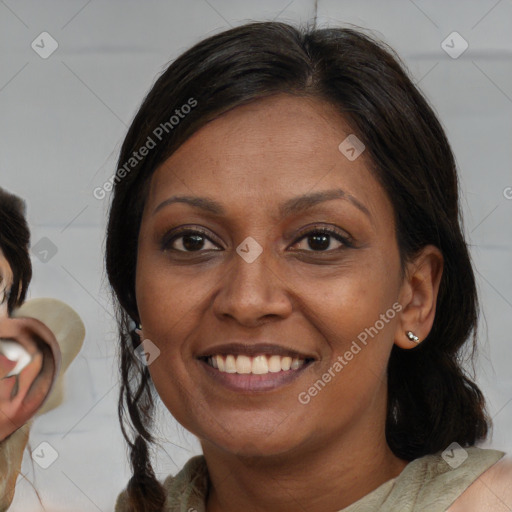 Joyful black adult female with medium  brown hair and brown eyes