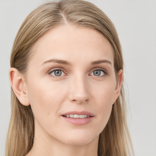 Joyful white young-adult female with long  brown hair and blue eyes