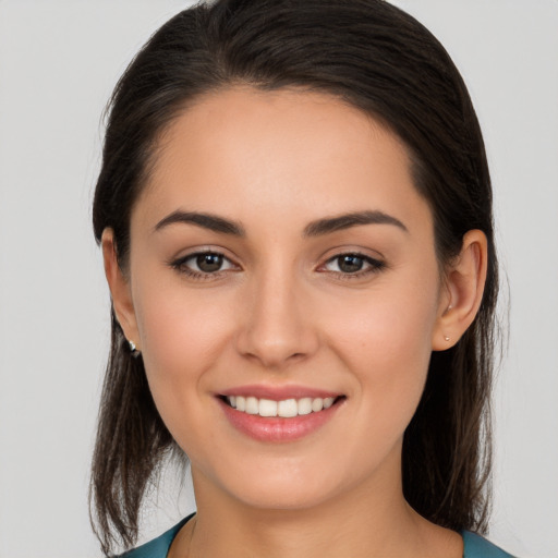 Joyful white young-adult female with long  brown hair and brown eyes