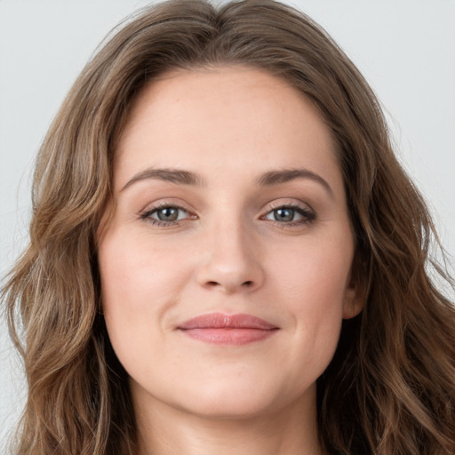 Joyful white young-adult female with long  brown hair and green eyes