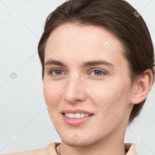 Joyful white young-adult female with short  brown hair and brown eyes