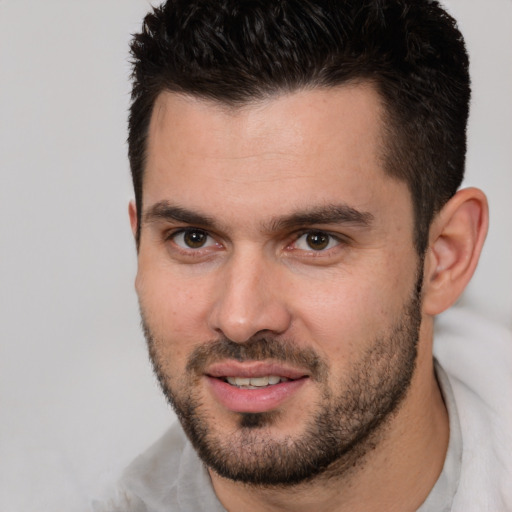 Joyful white young-adult male with short  brown hair and brown eyes