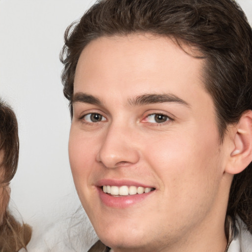 Joyful white young-adult male with medium  brown hair and brown eyes