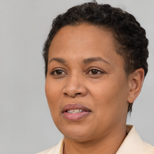 Joyful black adult female with short  brown hair and brown eyes