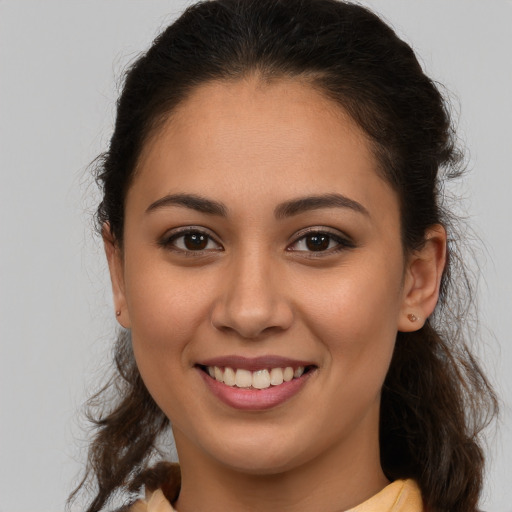 Joyful white young-adult female with long  brown hair and brown eyes