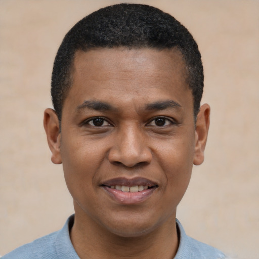 Joyful black young-adult male with short  black hair and brown eyes