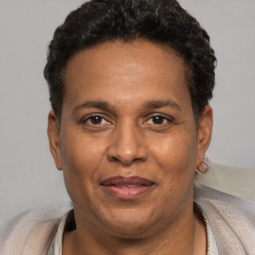 Joyful black adult male with short  brown hair and brown eyes