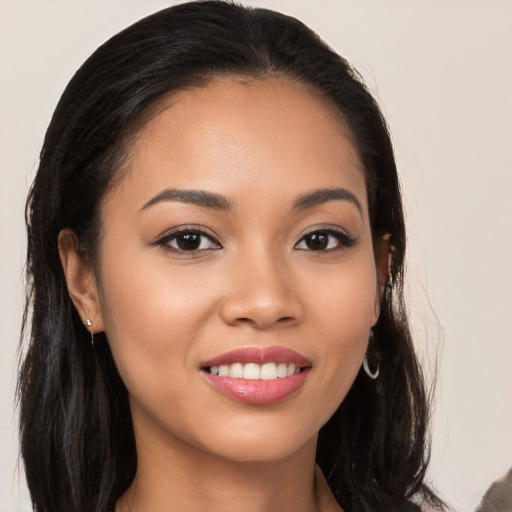 Joyful latino young-adult female with long  brown hair and brown eyes