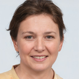 Joyful white adult female with medium  brown hair and brown eyes