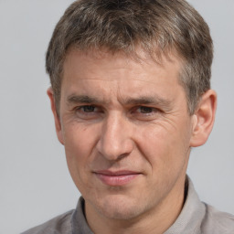 Joyful white middle-aged male with short  brown hair and brown eyes