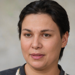 Joyful white adult female with medium  brown hair and brown eyes