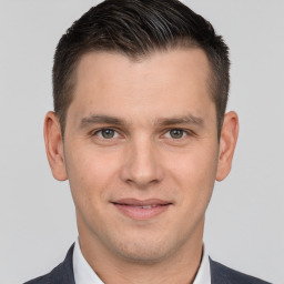 Joyful white young-adult male with short  brown hair and brown eyes