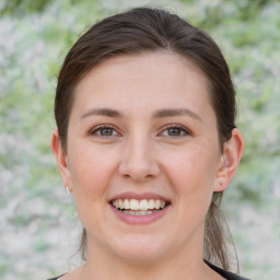 Joyful white young-adult female with medium  brown hair and brown eyes