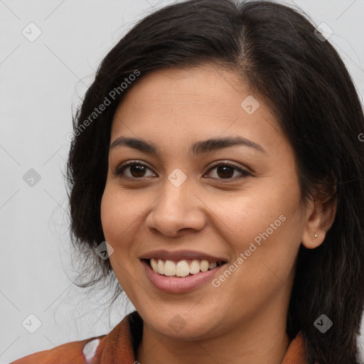 Joyful latino young-adult female with long  brown hair and brown eyes