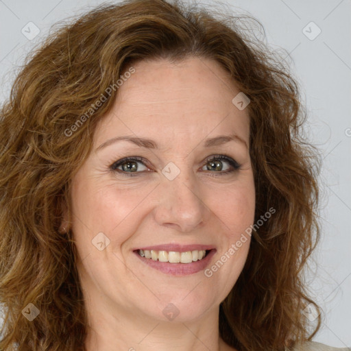 Joyful white adult female with long  brown hair and green eyes