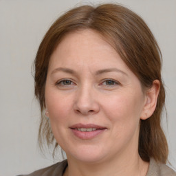 Joyful white adult female with medium  brown hair and grey eyes