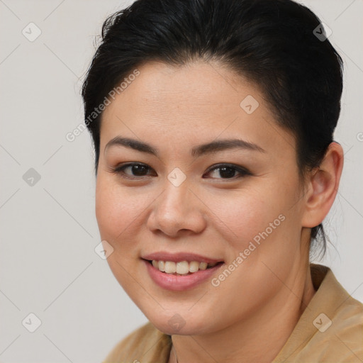 Joyful latino young-adult female with medium  brown hair and brown eyes