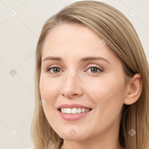 Joyful white young-adult female with long  brown hair and brown eyes