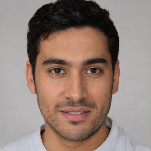 Joyful white young-adult male with short  black hair and brown eyes