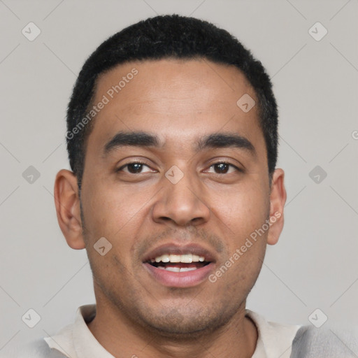 Joyful latino young-adult male with short  black hair and brown eyes