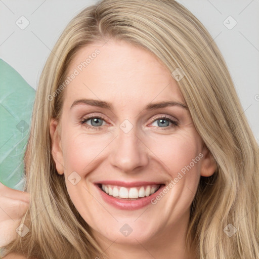 Joyful white young-adult female with long  brown hair and blue eyes