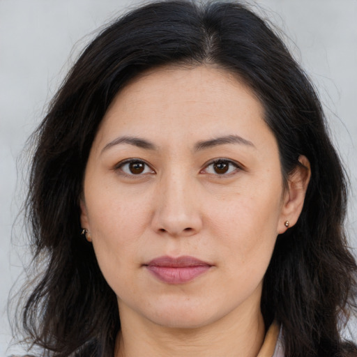 Joyful asian young-adult female with long  brown hair and brown eyes