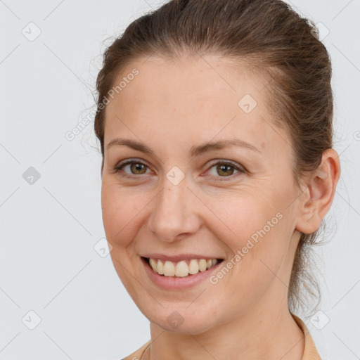 Joyful white young-adult female with long  brown hair and brown eyes