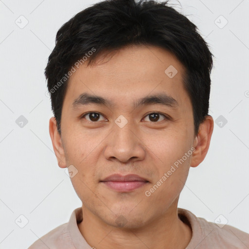 Joyful asian young-adult male with short  brown hair and brown eyes