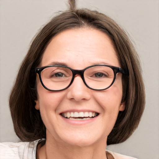 Joyful white adult female with medium  brown hair and blue eyes