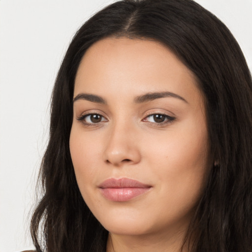 Joyful latino young-adult female with long  brown hair and brown eyes