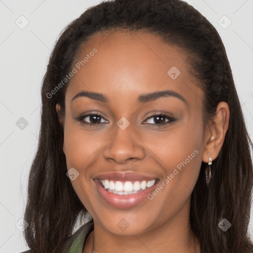 Joyful black young-adult female with long  brown hair and brown eyes