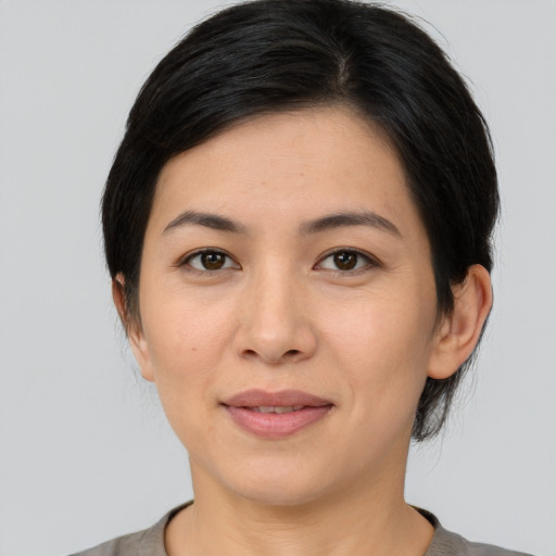 Joyful asian young-adult female with medium  brown hair and brown eyes