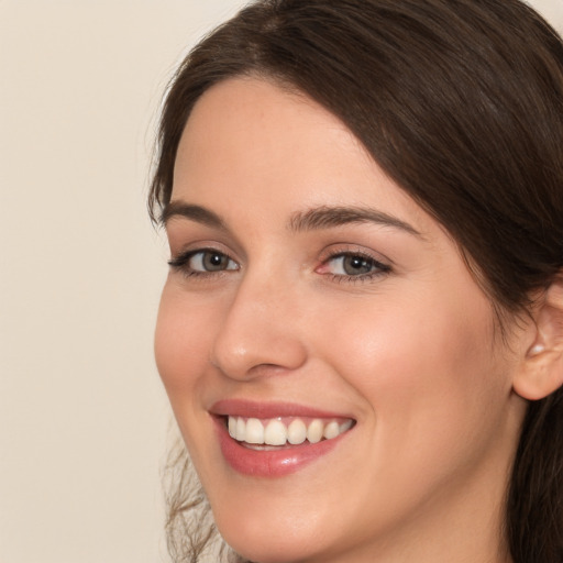 Joyful white young-adult female with medium  brown hair and brown eyes