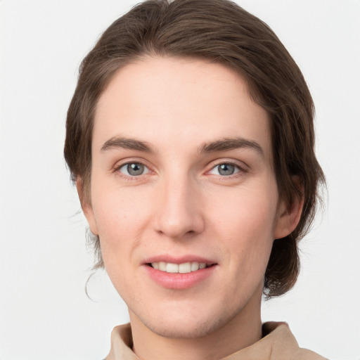 Joyful white young-adult female with short  brown hair and grey eyes