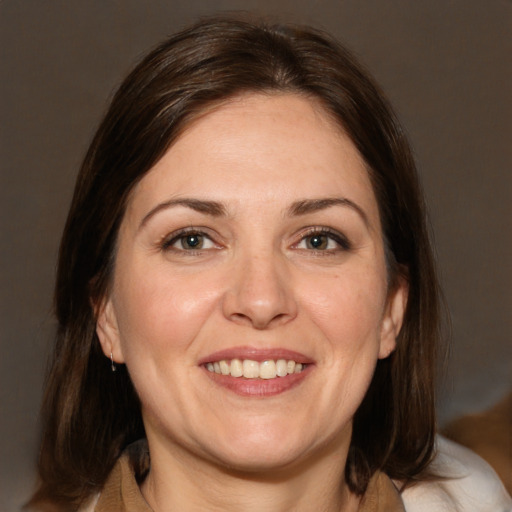 Joyful white adult female with medium  brown hair and brown eyes