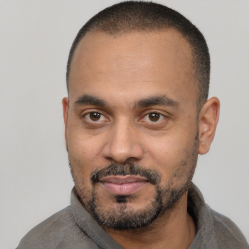 Joyful latino adult male with short  black hair and brown eyes