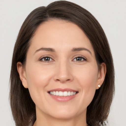 Joyful white adult female with medium  brown hair and brown eyes