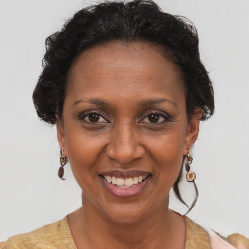 Joyful black adult female with short  brown hair and brown eyes