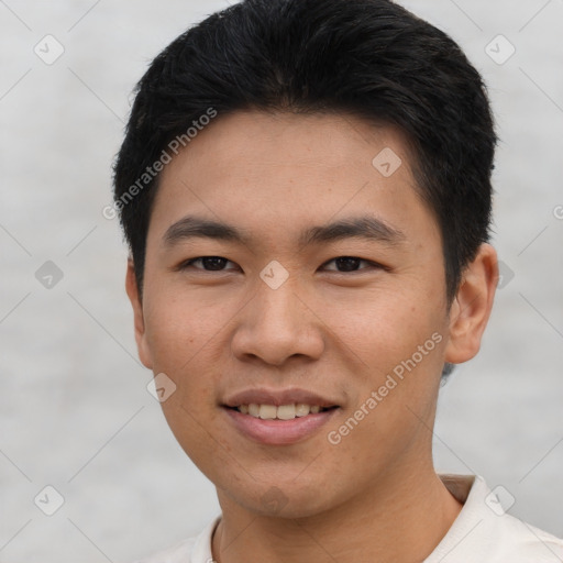 Joyful asian young-adult male with short  black hair and brown eyes