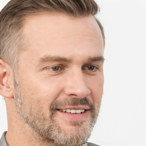 Joyful white adult male with short  brown hair and brown eyes