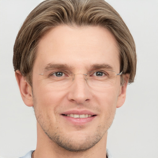 Joyful white adult male with short  brown hair and grey eyes