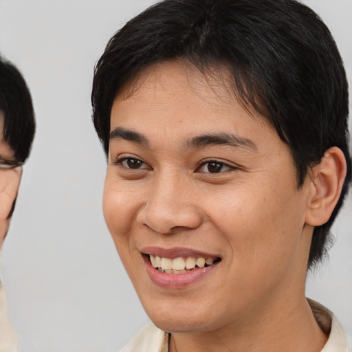 Joyful asian young-adult female with short  brown hair and brown eyes