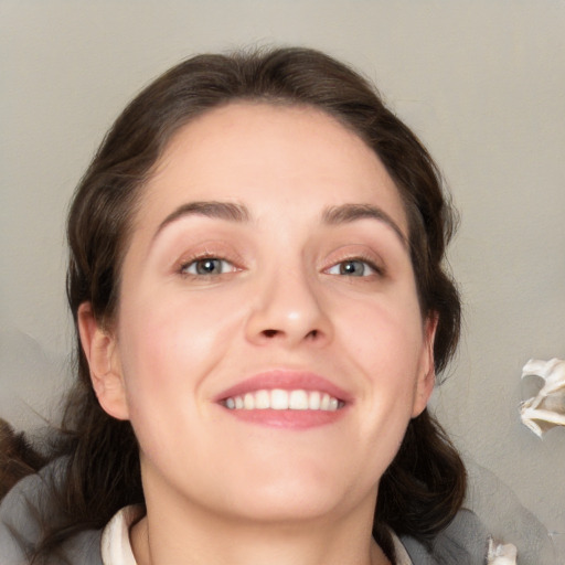 Joyful white young-adult female with medium  brown hair and blue eyes