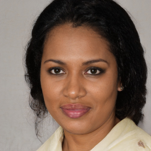 Joyful black adult female with medium  brown hair and brown eyes