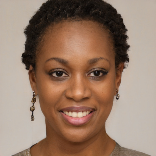 Joyful black young-adult female with short  brown hair and brown eyes