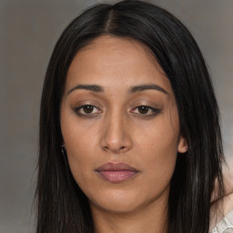 Joyful asian young-adult female with long  brown hair and brown eyes