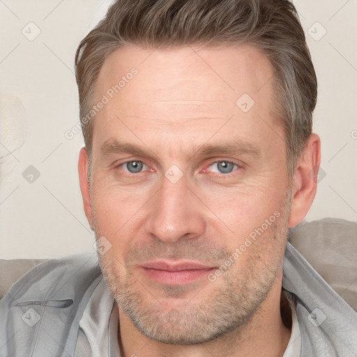 Joyful white adult male with short  brown hair and grey eyes