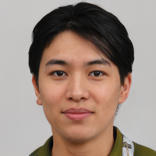 Joyful asian young-adult male with short  black hair and brown eyes