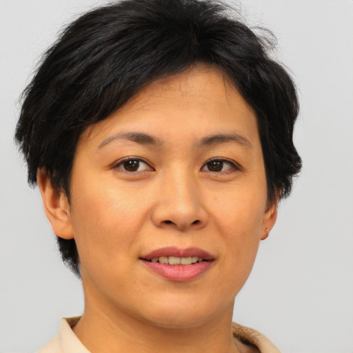 Joyful asian young-adult female with short  brown hair and brown eyes